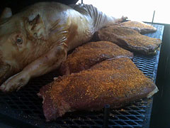 Pig with rubbed brisket on grill